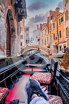 Riding a traditional gondola down the narrow canals in Venice, Italy.