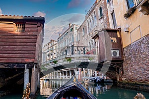 Riding a traditional gondola down the narrow canals in Venice, Italy.