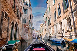 Riding a traditional gondola down the narrow canals in Venice, Italy.