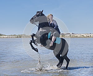 Riding woman on the beach