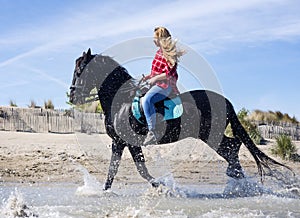 Riding woman on the beach