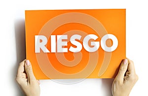 Riesgo spanish words for Risk text quote, concept background