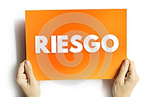 Riesgo spanish words for Risk text quote, concept background photo