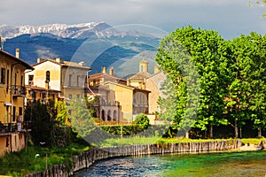 Rieti, city of central Italy. Fiume Velino with ancient houses and the Terminillo mountain at the top