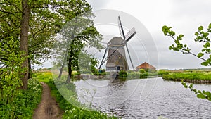 Rietveldse Molen, is a historic wind mill by the canal, located near Zoetermeer in the Netherlands photo