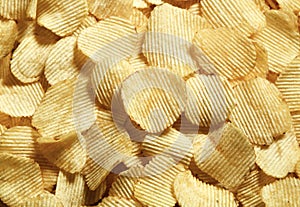 Riffle golden chips with texture potato background