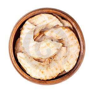 Riffled apple chips, dehydrated apple slices, in a wooden bowl