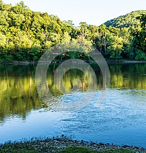 Riffles in the Allegheny river at dusk with shadows on the opposite river side on Althom, Pennsylvania, USA