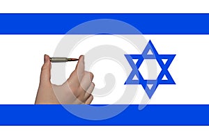 A rifle cartridge in a hand against the background of the Israeli flag