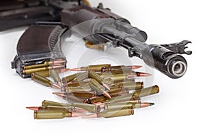 Rifle cartridges against the assault rifle, close-up, selective focus