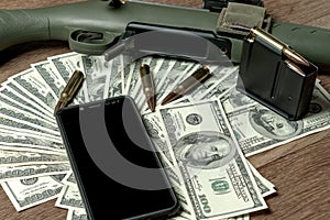 Rifle, magazine and cartridges on money. Concept for crime, contract killing, paid assassin, terrorism, war, global arms