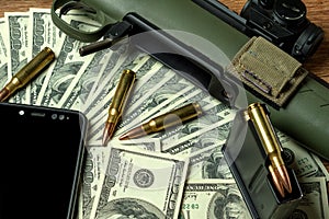 Rifle, magazine and cartridges on money. Concept for crime, contract killing, paid assassin, terrorism, war, global arms