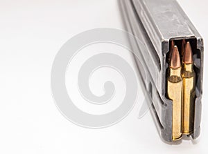 A rifle magazine loaded with 556 bullets on a white background