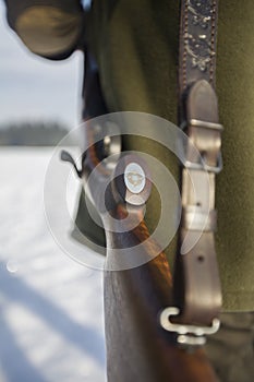 The rifle over the hunters shoulder, useful for hunting articles or news