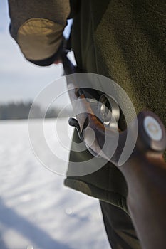 The rifle over the hunters shoulder, useful for hunting articles or news