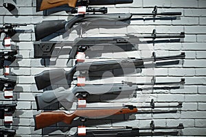 Rifles on showcase in gun shop closeup, nobody