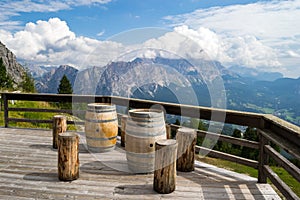 Rifugio Duca D`Aosta with wooden barrels as tables for tourists taking a break in the Italian Dolomites mountains photo
