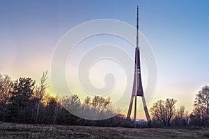 Riga. Famous Landmark Television Tower Natural Sunset Or Sunrise Colors Sky.