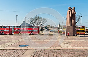 Riflemen Square with Monument to Latvian Red Riflemen and city tour bus in the historic center of Riga, Latvia