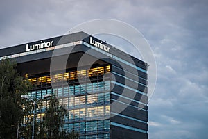 Riga/Latvia - August 2, 2020: Luminor bank building and Luminor logo at evening. Defocused