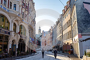 Riga / Latvia - 03 December 2019:Riga old town street with medieval buildings in winter day. Narrow street in Riga, Latvia