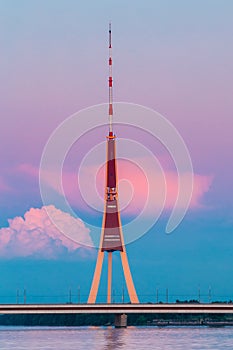 Riga, Latvia. Famous Landmark Television Tower In Pink Purple Sunset