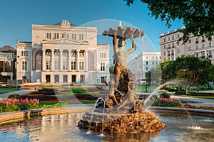 Riga, Latvia. Fountain Nymph In Water Splashes In Aspazijas Boulevard Near National Opera