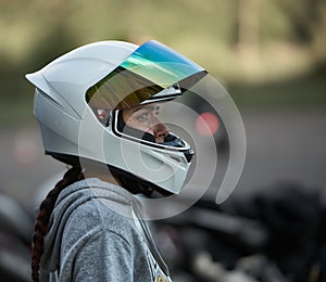 Riga, Latvia - 19.06.2019 Happy biker woman with a road helmet and thumb up isolated on a white background