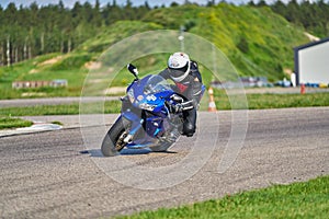 12-05-2020 Riga, Latvia. man on a motorbike on the road riding. having fun driving the empty road on a motorcycle tour journey