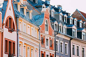 Riga Latvia. Mansard Tile Roof With Four Gable Fronted Dormer Windows On The Old Building Under Blue Sky