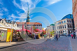 RIGA, LATVIA - MAY 06, 2017: View on the colored cozy old houses, churches and Dome Square with street cafes that are located i