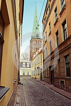 Riga, Latvia. Narrow medieval cobbled Maza Miesnieku iela street with tenement houses in the old town of Riga.