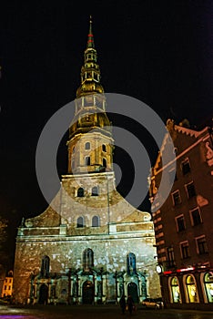 Riga, Latvia: Night View Of St. Peter`s Church In Old Town Riga Latvia. Illuminated Street