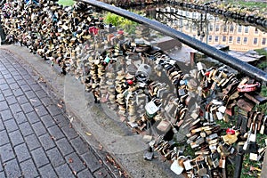 Riga, Latvia, November 2019. Iron castles as a symbol of the strength of marriage on the fence of the bridge.