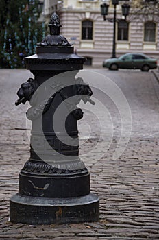 Riga, Latvia. Road pillar with lions heads at Torna street in old town photo