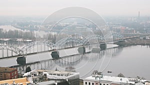 Riga, Latvia. Top view of railway bridge through daugava or western Dvina River In Misty Fog Rainy Day