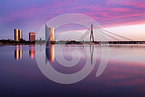 Riga view on cable-braced bridge over Daugava river and new buildings at other bank of it.