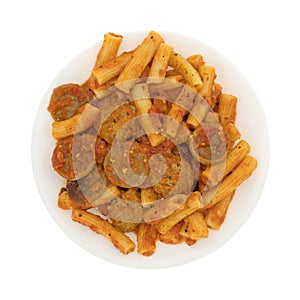 Rigatoni pasta with meatballs and sausage on a plate