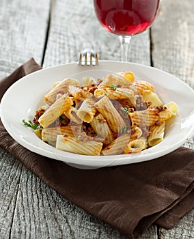 Rigatoni pasta with tomato meat sauce and wine