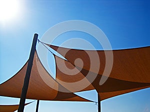 RIGGED CANVAS COVERS AGAINST THE BLUE SKY