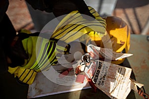 Rigger inspector high risk worker inspecting checking yellow three lifting sling