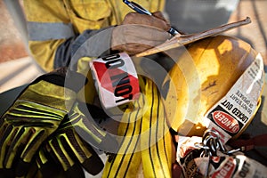 Rigger inspector high risk worker   inspecting checking yellow three lifting sling with red danger tag photo