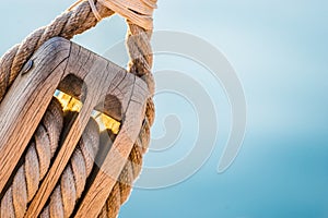 Rigging, maritime scene, close-up of wooden pulley with nautical ropes