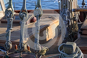 Rigging, ropes and knots on a historical wooden sailing ship on a sunny day on the sea