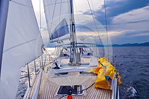 View from a sailboat`s bow with mast and full sails photo