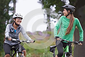 Right behind you. Two young cyclists enjoying their ride along a trail.