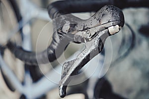 Right brake lever on a gravel bike covered with rain drops on a drop flared bar