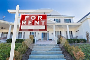 Right Facing For Rent Real Estate Sign In Front of House.