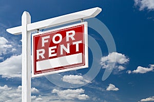 Right Facing For Rent Real Estate Sign Over Blue Sky and Clouds