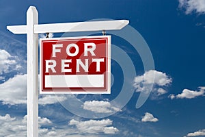 Right Facing For Rent Real Estate Sign Over Blue Sky and Clouds